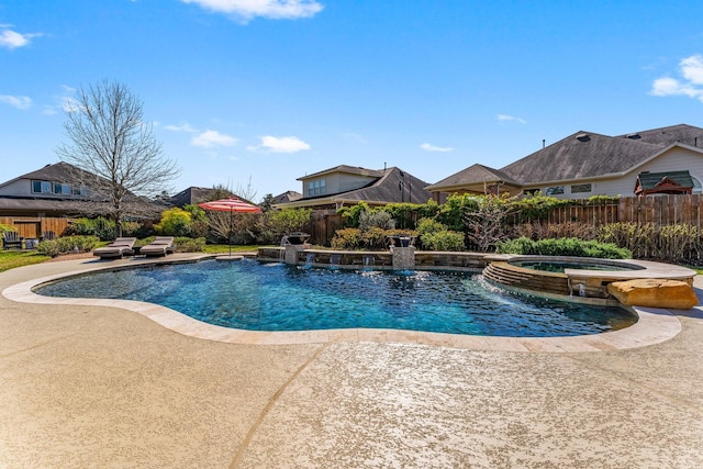 view of pool with a pool with connected hot tub, a patio, and fence