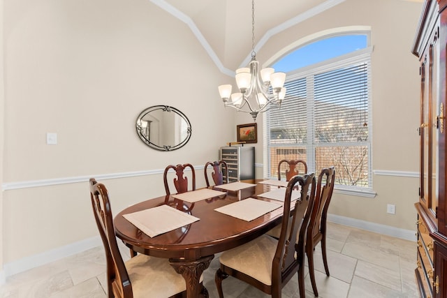 dining area with baseboards, high vaulted ceiling, a chandelier, and ornamental molding