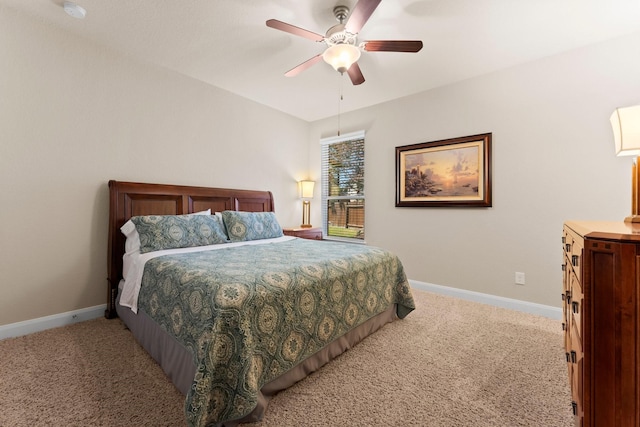 carpeted bedroom featuring baseboards and ceiling fan