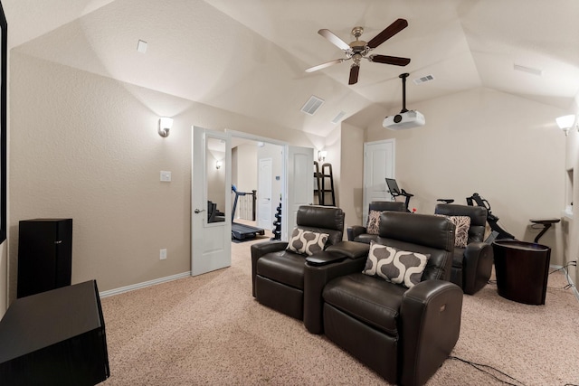 carpeted cinema room with visible vents, baseboards, ceiling fan, and vaulted ceiling