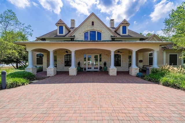 rear view of property with french doors, brick siding, a porch, and ceiling fan