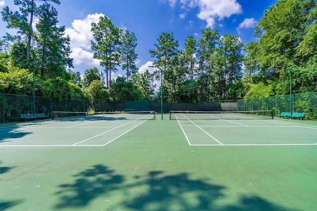 view of tennis court with fence