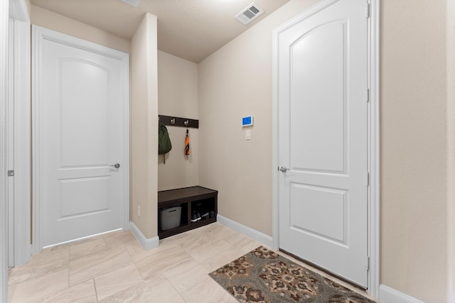 mudroom with baseboards and visible vents