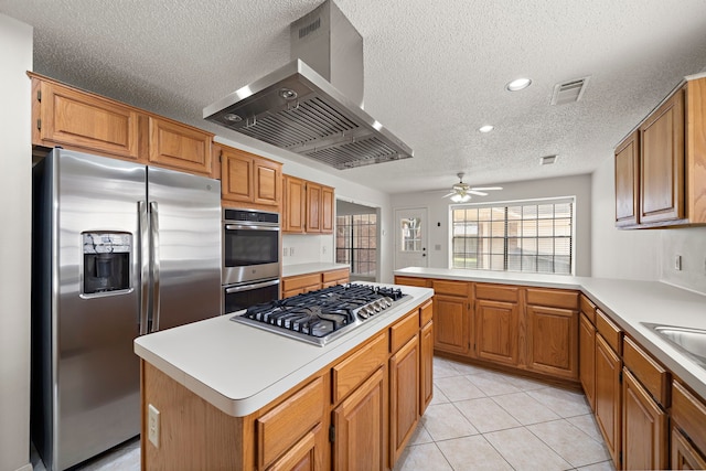 kitchen featuring range hood, light tile patterned floors, visible vents, light countertops, and appliances with stainless steel finishes