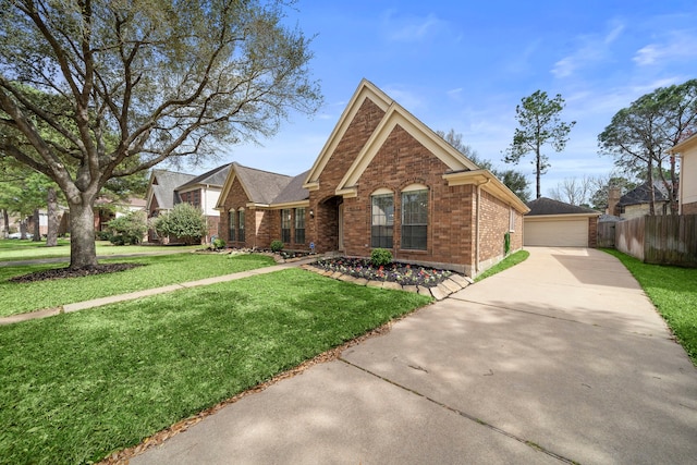 view of front of house featuring a front lawn, a detached garage, fence, an outdoor structure, and brick siding