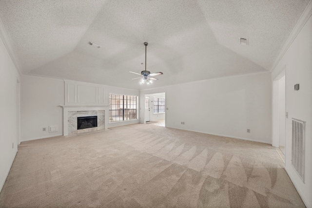 unfurnished living room featuring visible vents, light carpet, and lofted ceiling