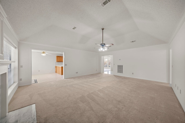 unfurnished living room featuring visible vents, light colored carpet, a fireplace, and vaulted ceiling