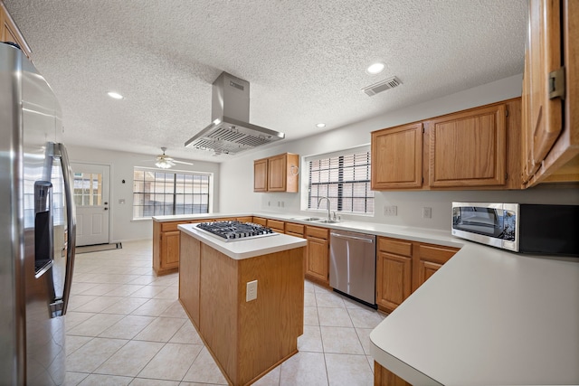 kitchen with visible vents, light countertops, light tile patterned floors, island range hood, and stainless steel appliances