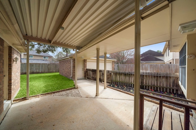 view of patio with an outdoor structure and a fenced backyard