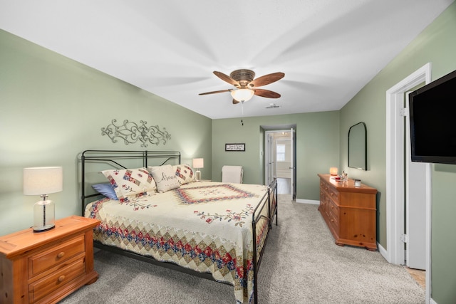 carpeted bedroom with visible vents, baseboards, and ceiling fan