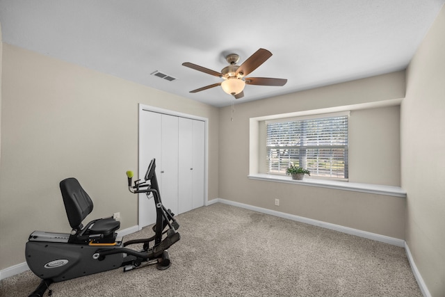 exercise room with a ceiling fan, baseboards, visible vents, and carpet floors