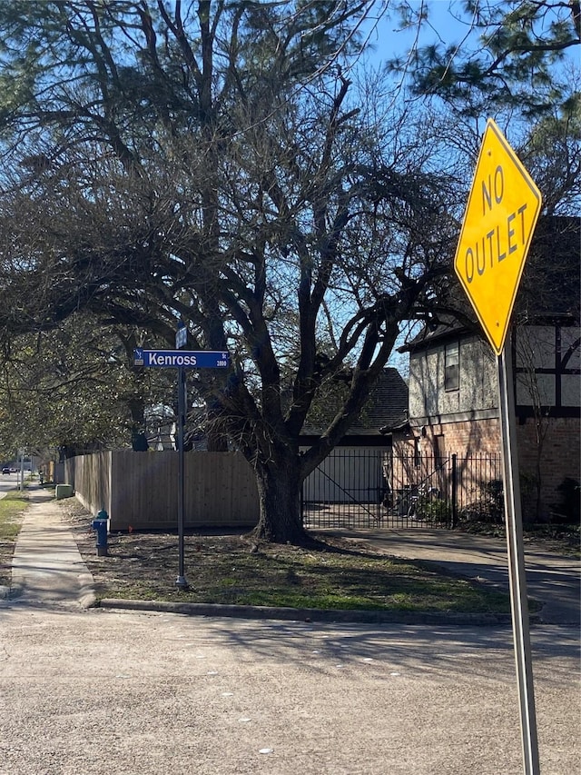 exterior space featuring curbs, traffic signs, and sidewalks