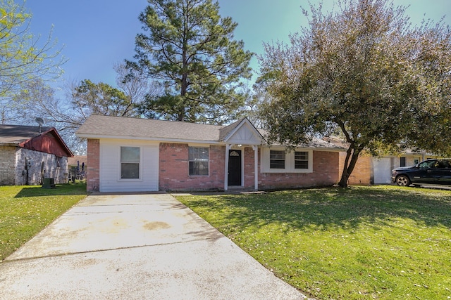 ranch-style home featuring a front yard and brick siding