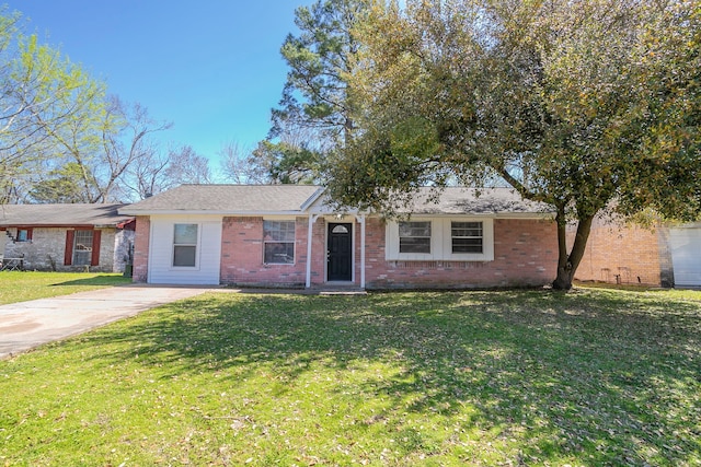 ranch-style house with brick siding, concrete driveway, and a front lawn