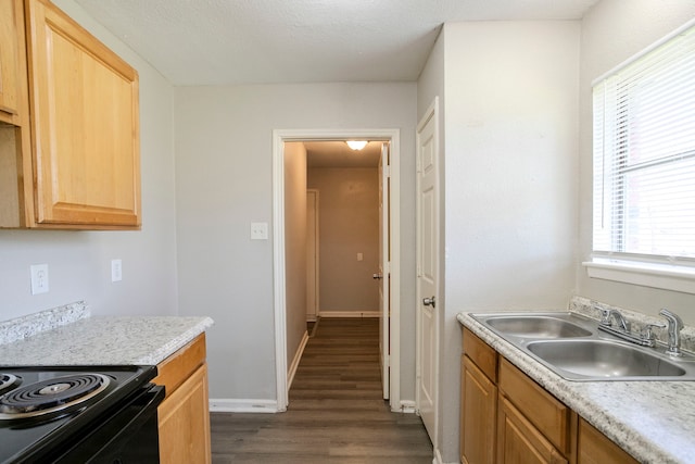 kitchen featuring a sink, baseboards, light countertops, black electric range, and dark wood-style flooring