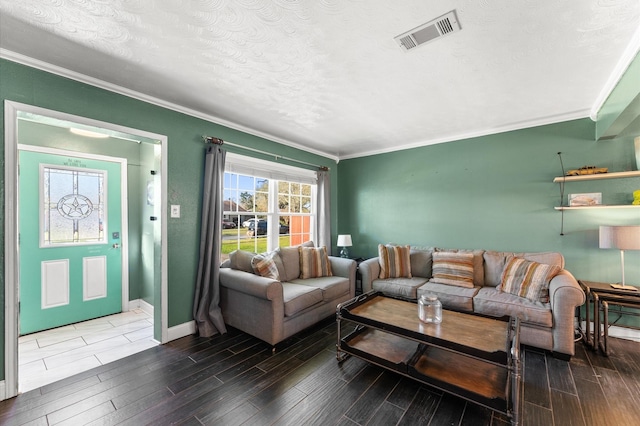 living area with visible vents, ornamental molding, a textured ceiling, baseboards, and wood tiled floor