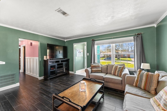 living room featuring visible vents, crown molding, and wood finished floors