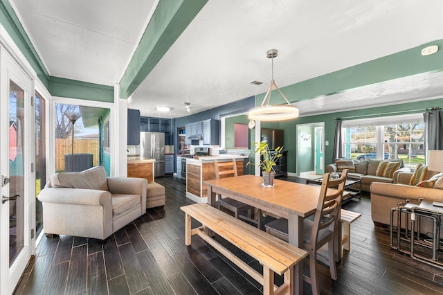 dining space with visible vents and dark wood-type flooring