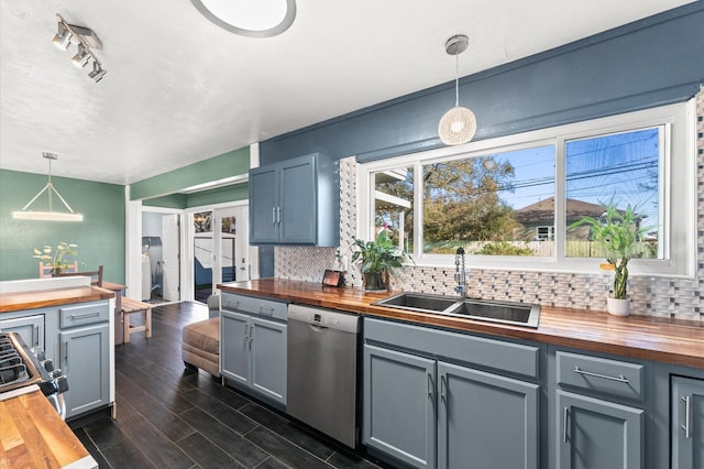 kitchen with appliances with stainless steel finishes, wooden counters, gray cabinetry, and a sink