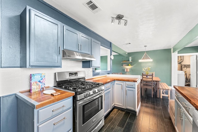 kitchen with visible vents, dark wood finished floors, stainless steel range with gas stovetop, under cabinet range hood, and wood counters