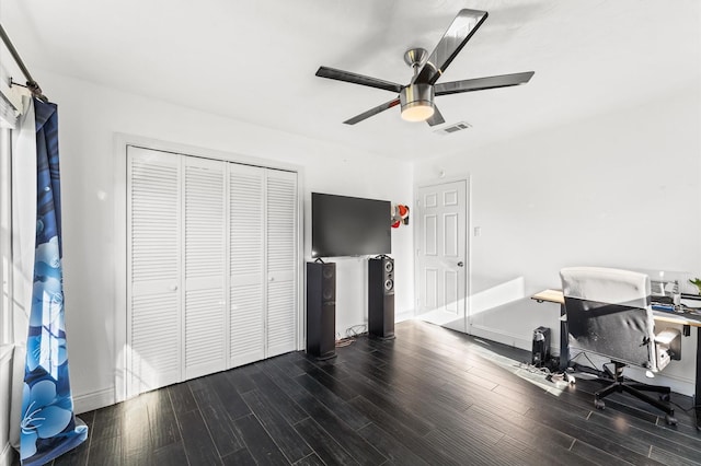 office area featuring ceiling fan, visible vents, baseboards, and wood finished floors