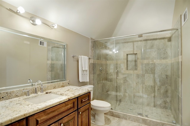 full bathroom featuring visible vents, toilet, a stall shower, and vanity