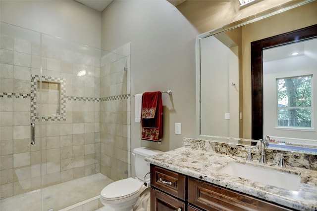 full bathroom with toilet, a stall shower, and vanity