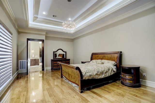 bedroom with visible vents, crown molding, a raised ceiling, and wood finished floors