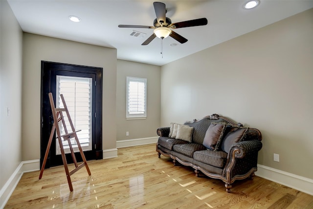 living area with recessed lighting, baseboards, visible vents, and light wood finished floors