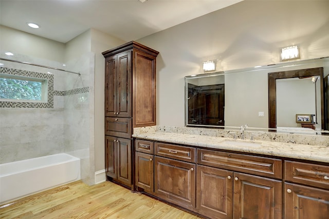 full bathroom with shower / bathtub combination, wood finished floors, and vanity