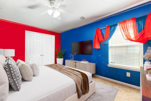 carpeted bedroom featuring a ceiling fan, baseboards, visible vents, and a closet