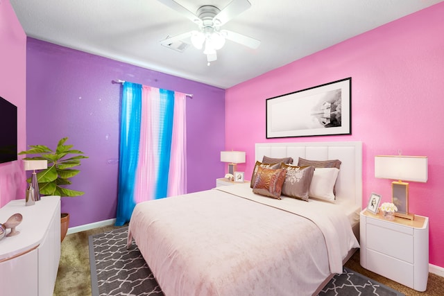 carpeted bedroom featuring baseboards and a ceiling fan