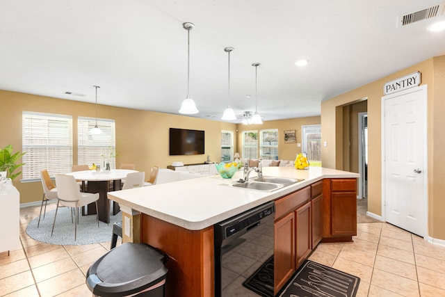 kitchen with light tile patterned floors, visible vents, a sink, black dishwasher, and open floor plan