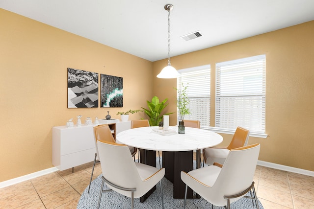 dining space with light tile patterned floors, visible vents, and baseboards