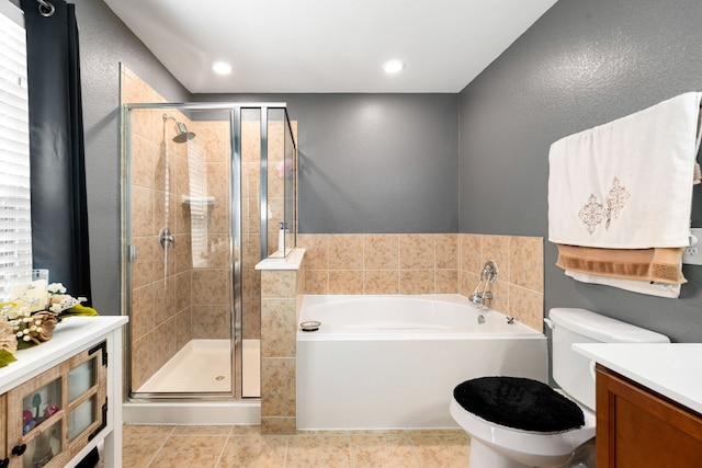 full bathroom featuring vanity, a bath, a shower stall, and toilet