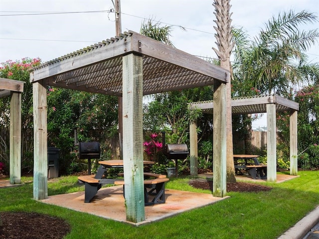 surrounding community with a lawn, a pergola, a patio, and fence