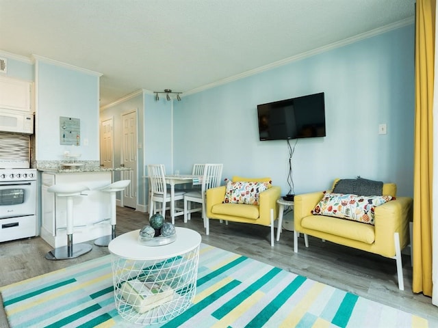 living room with wood finished floors and ornamental molding