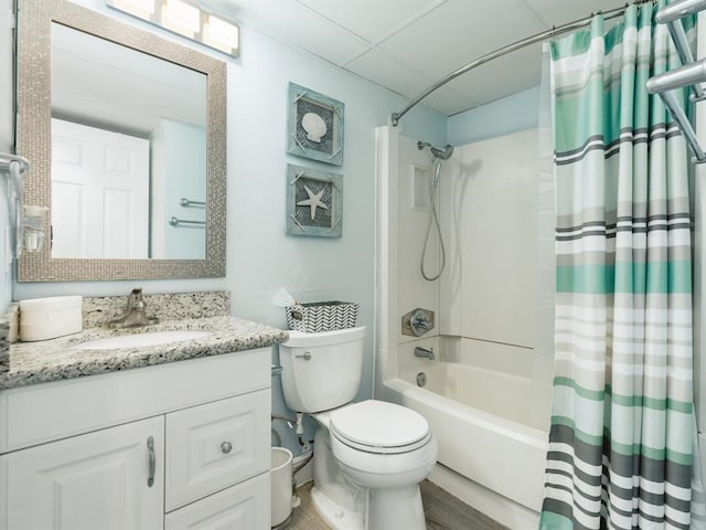 bathroom with vanity, toilet, a paneled ceiling, and shower / bath combo