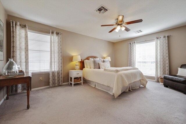 bedroom with visible vents, carpet floors, baseboards, and ceiling fan