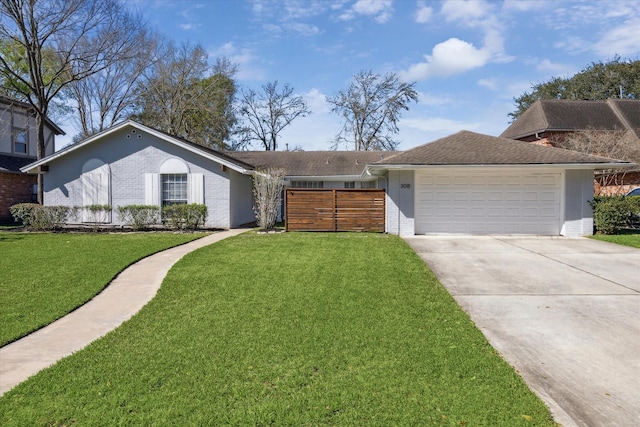 view of front of property with a garage, brick siding, concrete driveway, and a front lawn