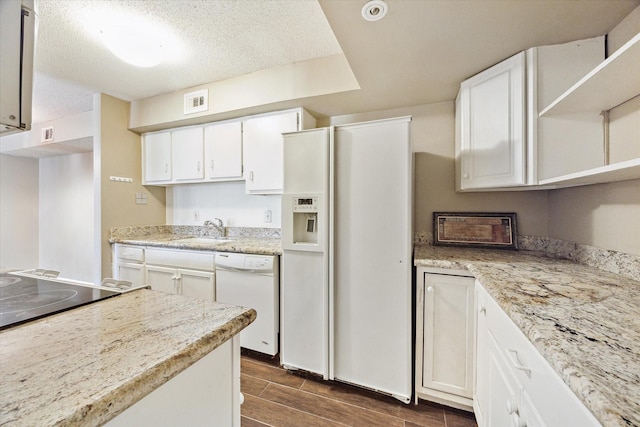 kitchen featuring white appliances, wood tiled floor, open shelves, light countertops, and white cabinets