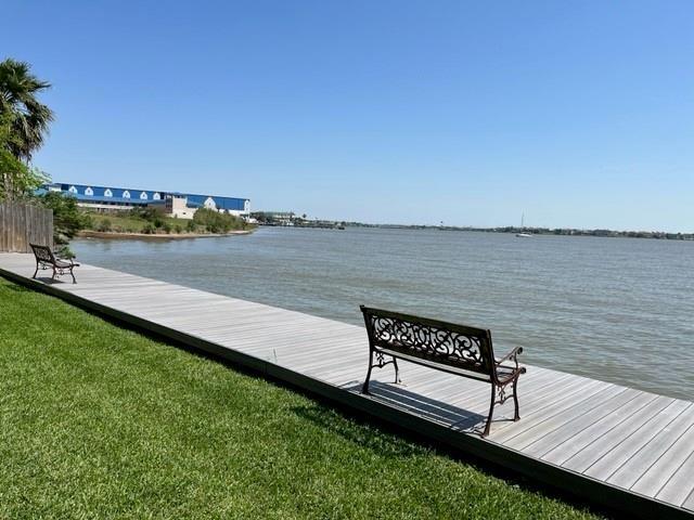 dock area with a yard and a water view