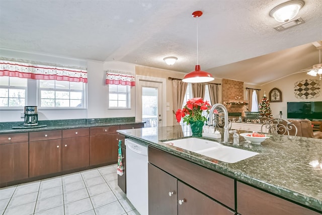 kitchen with visible vents, a sink, open floor plan, white dishwasher, and light tile patterned floors