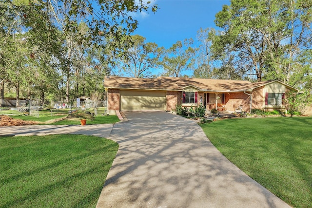 ranch-style house with a front yard, an attached garage, brick siding, and driveway