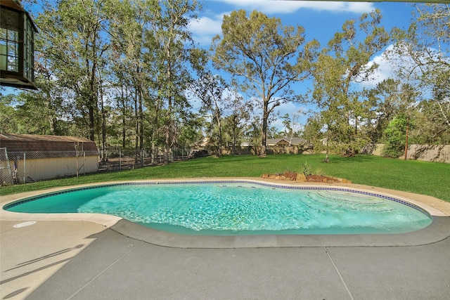 view of swimming pool with a patio, a lawn, a fenced in pool, and a fenced backyard