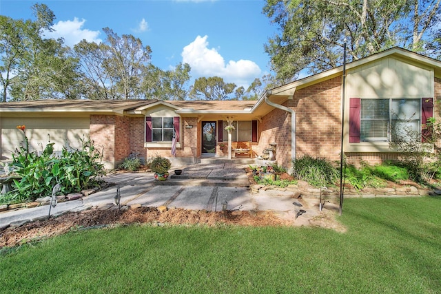 view of front of property with brick siding and a front lawn