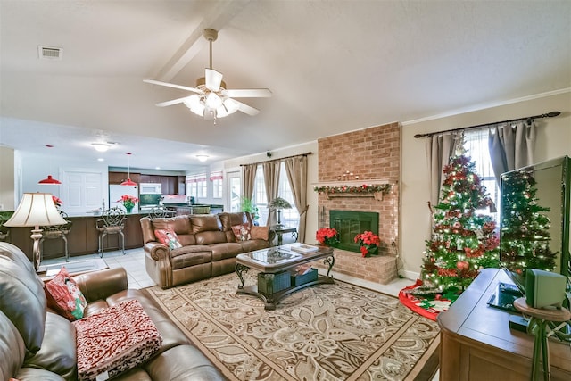 living room featuring visible vents, a brick fireplace, vaulted ceiling with beams, light tile patterned floors, and a ceiling fan