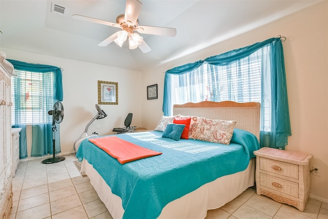 tiled bedroom featuring visible vents, baseboards, and ceiling fan