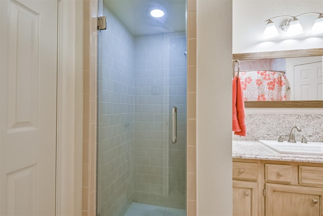 bathroom with a stall shower and vanity