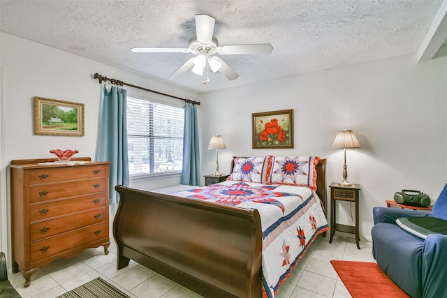 bedroom with ceiling fan, a textured ceiling, and light tile patterned flooring